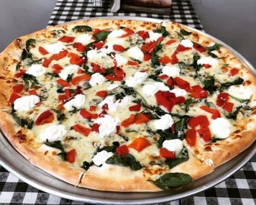 white spinach and tomato pizza